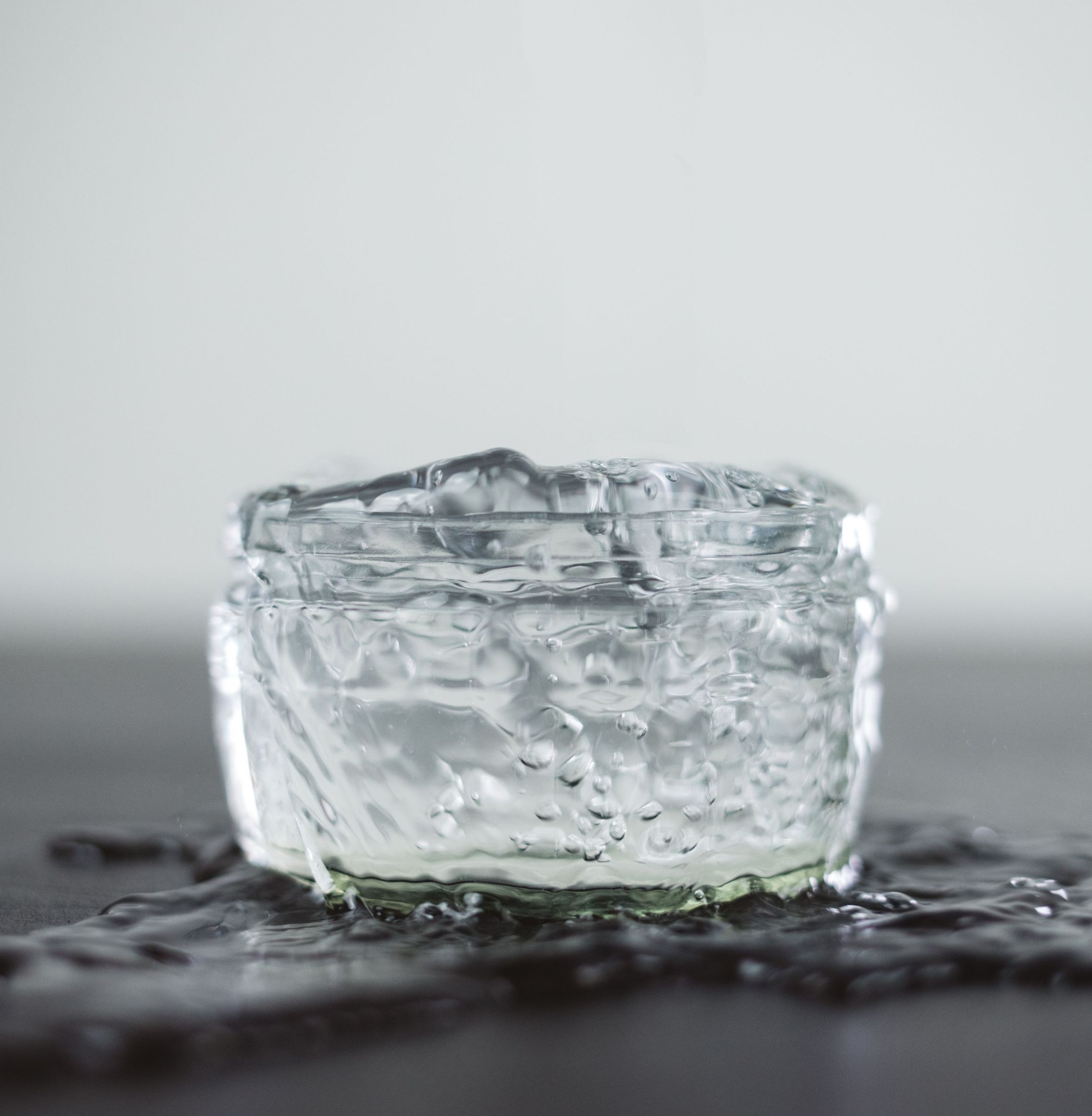 Block of clear ice on a dark surface