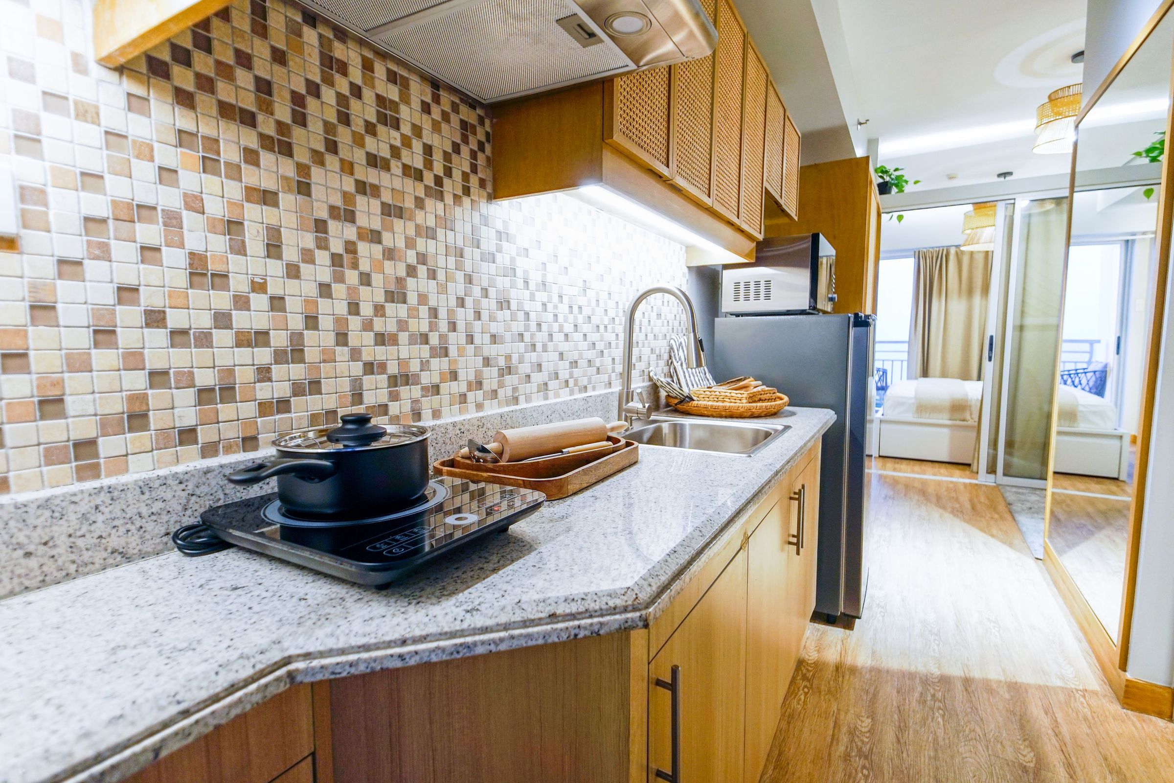 Compact kitchen with a cooktop, refrigerator and microwave